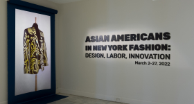 Exhibit entrance shows title of exhibit and an image of a black and yellow jacket.