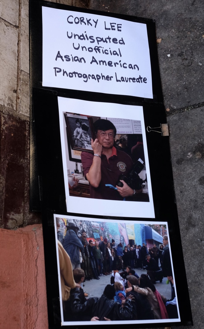 Photo of a tribute with a photo of Corky Lee with a caption: "Corky Lee. Undisputed Unofficial Asian American Photographer Laureate."